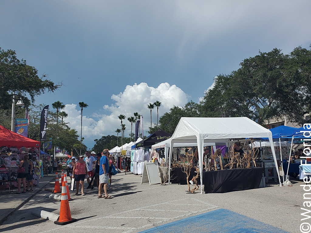 GeckoFest: Gulfport's Epic Way to End the Summer 1 White and blue tents line the main street in Gulfport with vendors selling arts, crafts, and food.