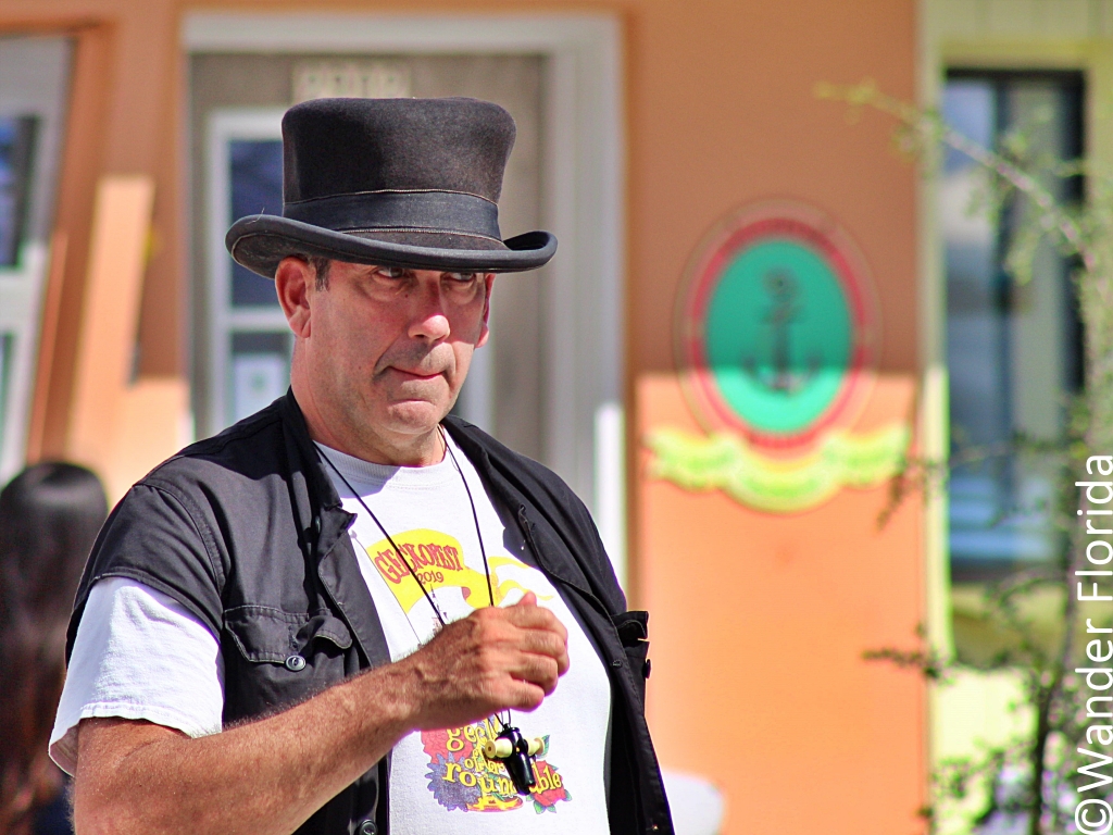 GeckoFest: Gulfport's Epic Way to End the Summer 5 A man in a black vest, white Geckofest t-shirt, and black top hat.